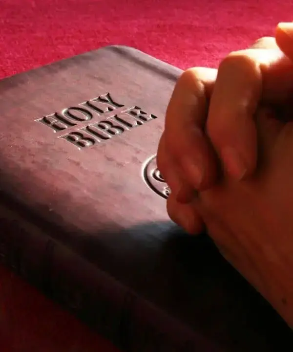 Hand place on a bible on a table