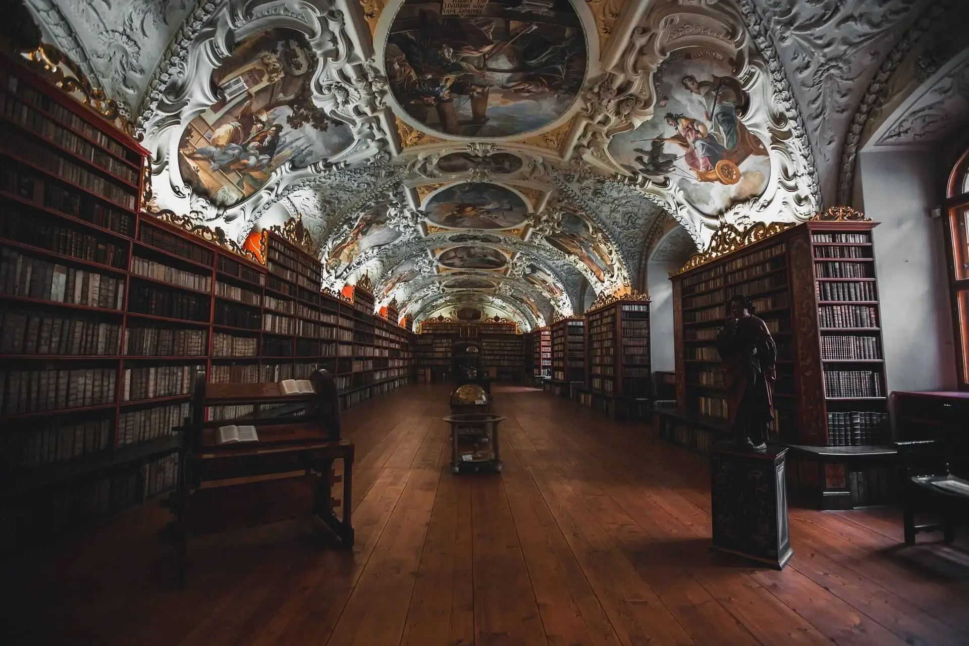 Ornate library with painted ceiling.