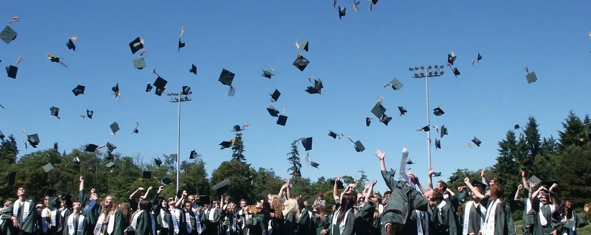 Graduated students throwing caps into the air.